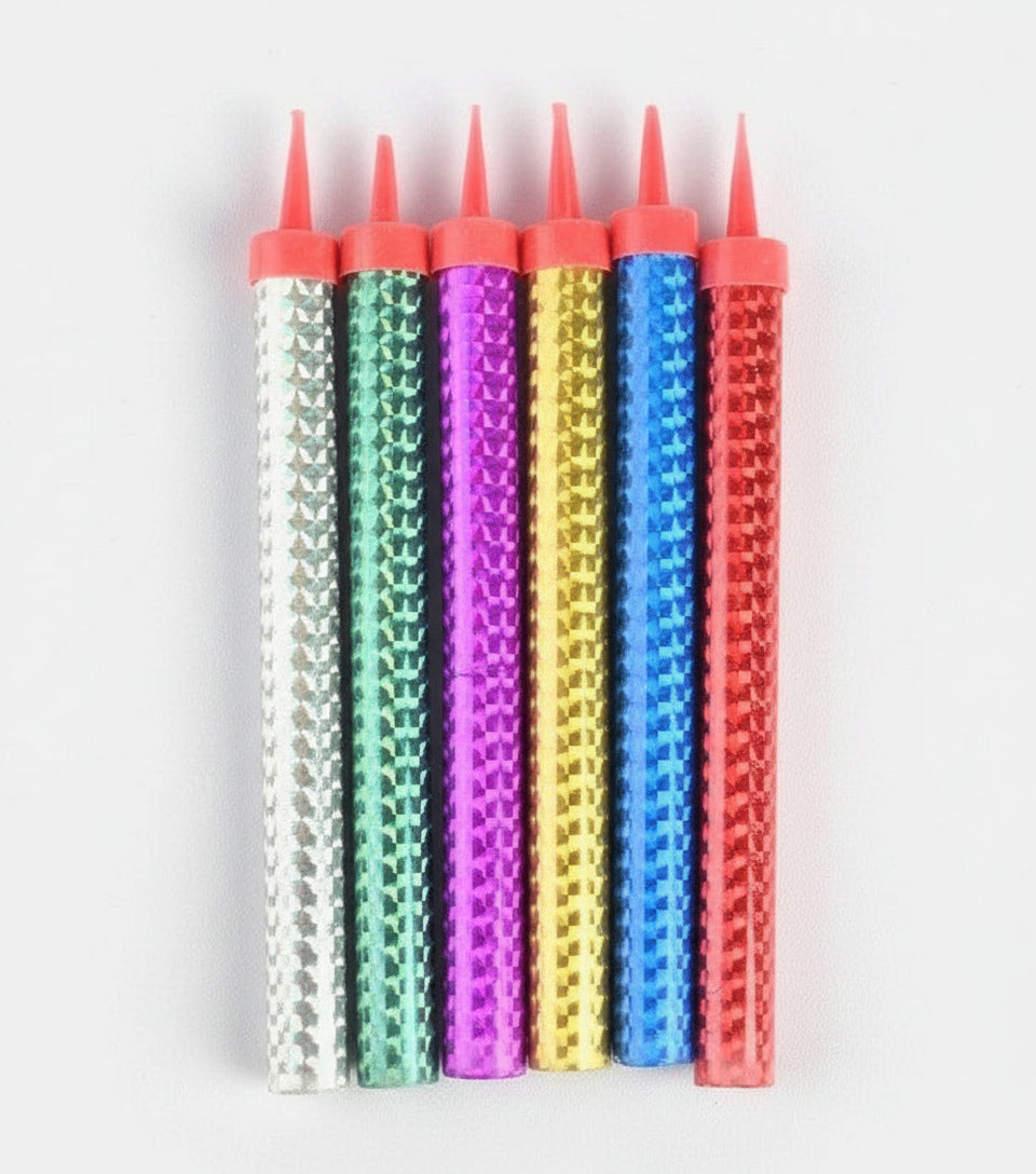 Packaged birthday candles with colorful wicks on a white background